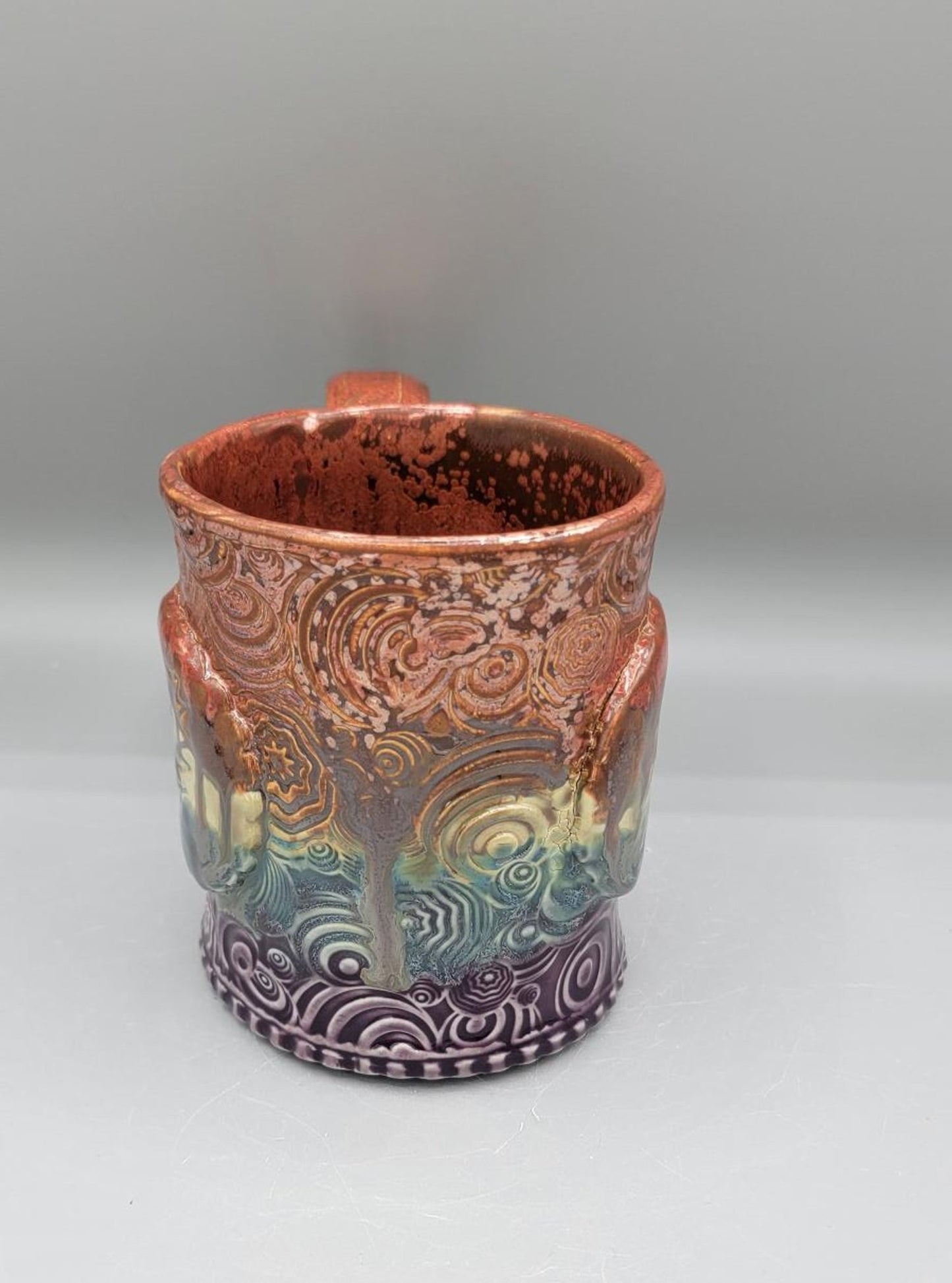 14-15 oz Embossed Trippy Circles Mug with Bolt Medallion in Melting Copper to Purple