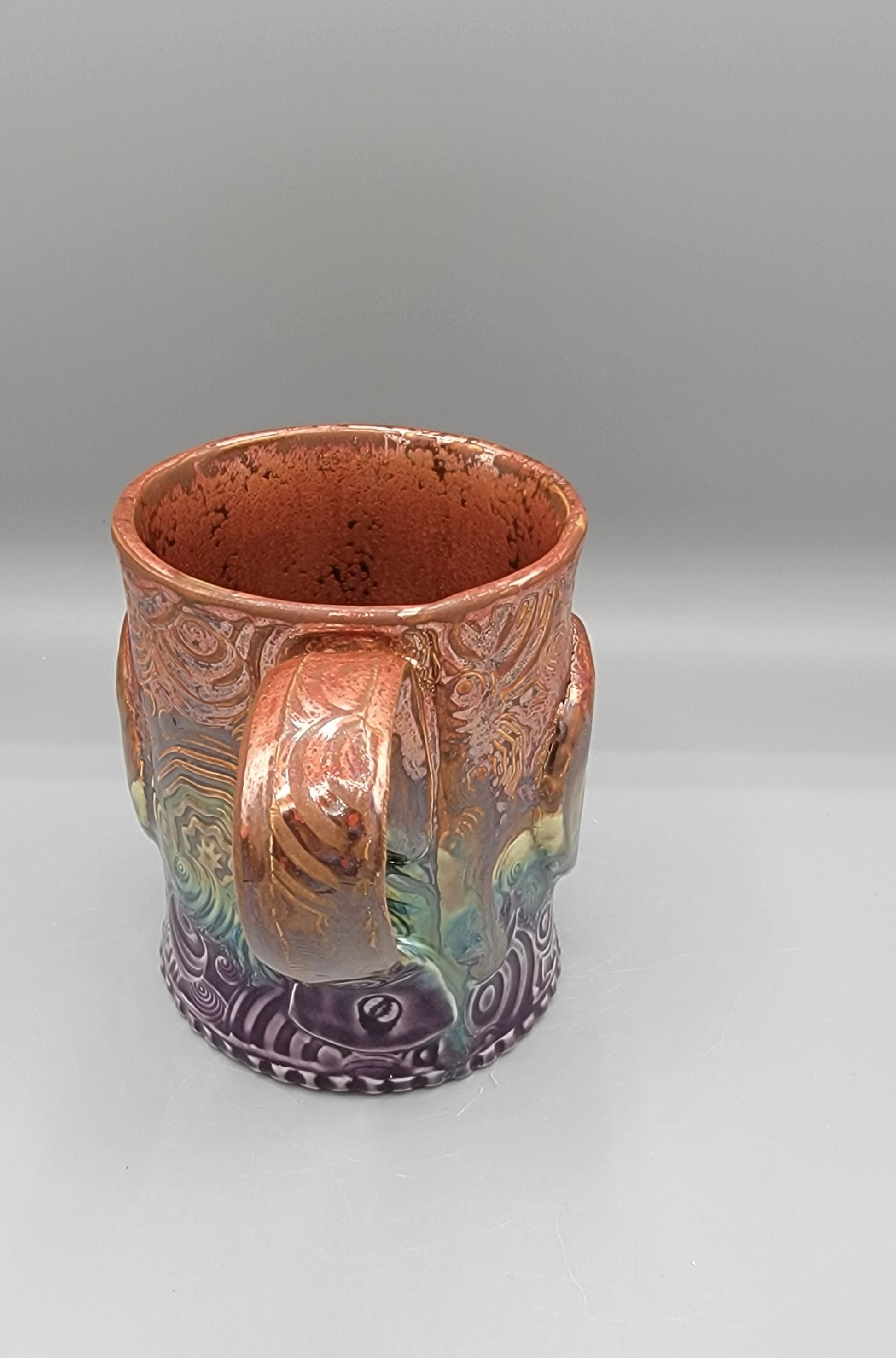 14-15 oz Embossed Trippy Circles Mug with Bolt Medallion in Melting Copper to Purple