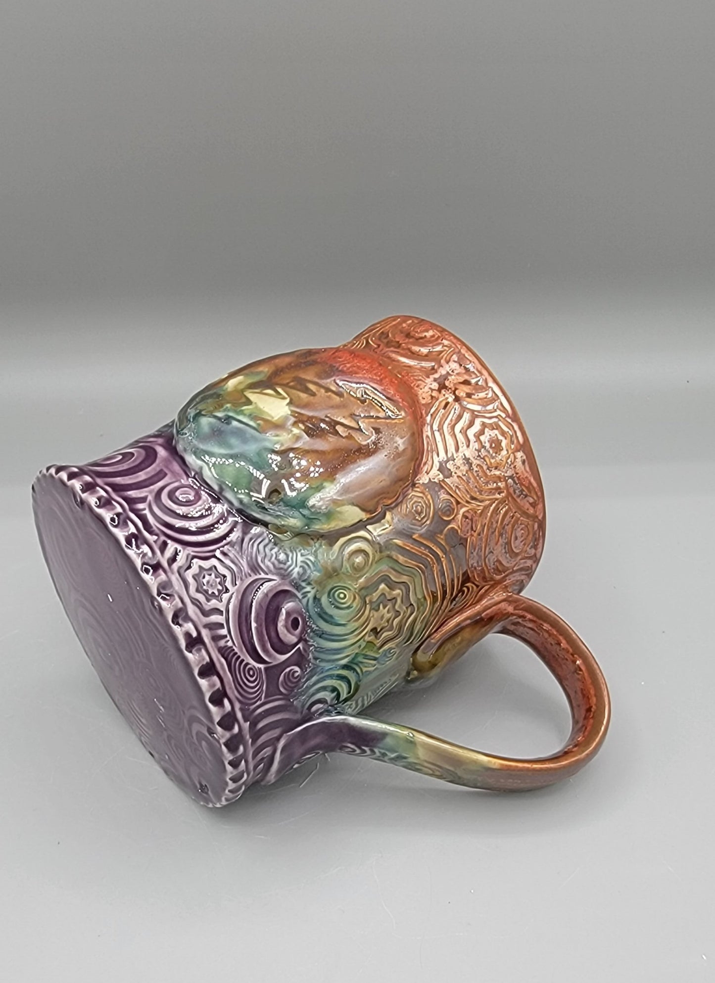 14-15 oz Embossed Trippy Circles Mug with Bolt Medallion in Melting Copper to Purple