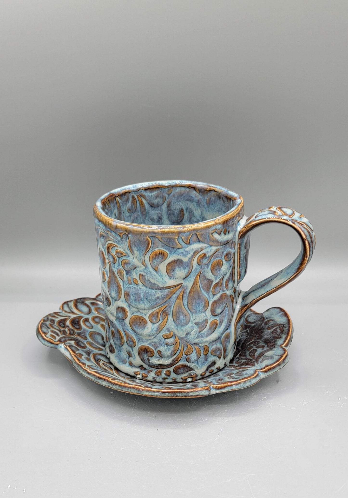 Embossed Paisley Ceramic Mug with Matching Fancy Saucer in Floating Blue