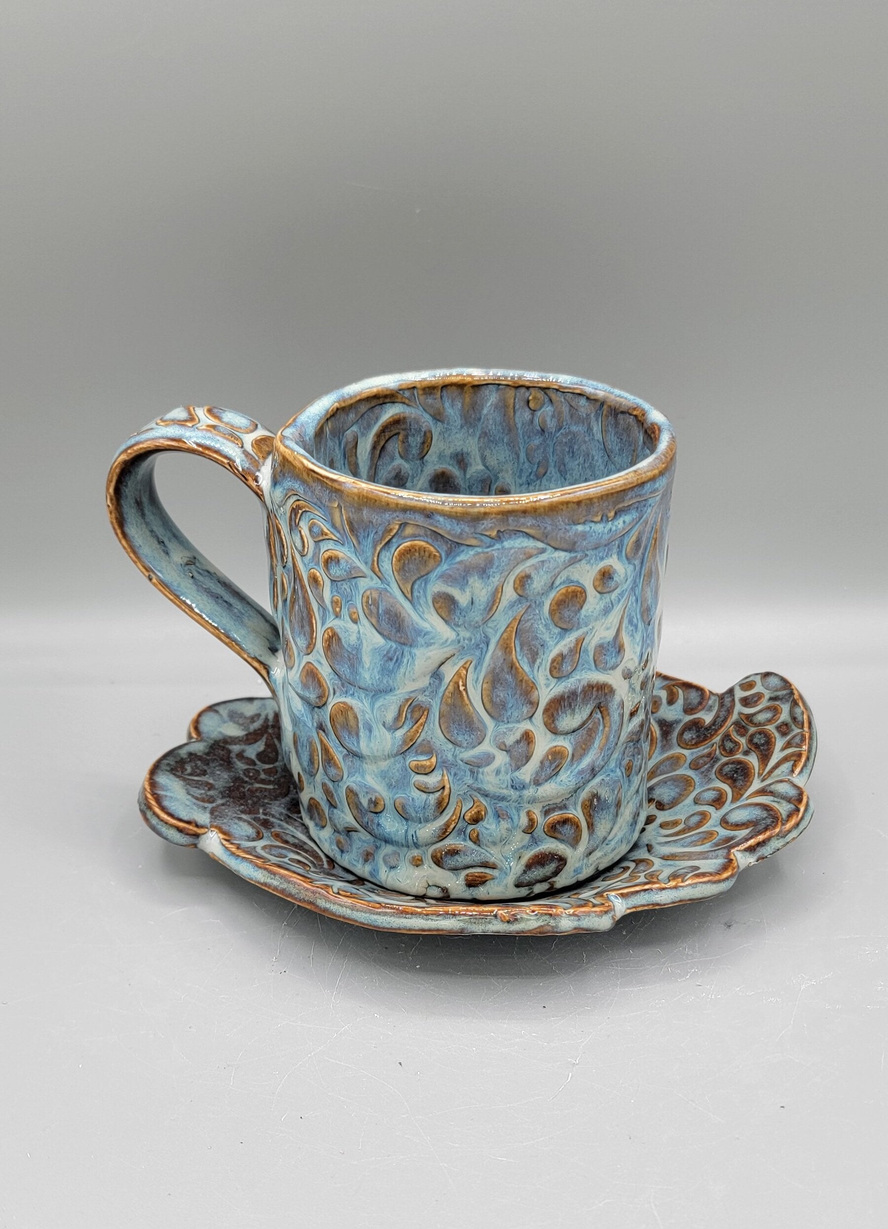 Embossed Paisley Ceramic Mug with Matching Fancy Saucer in Floating Blue