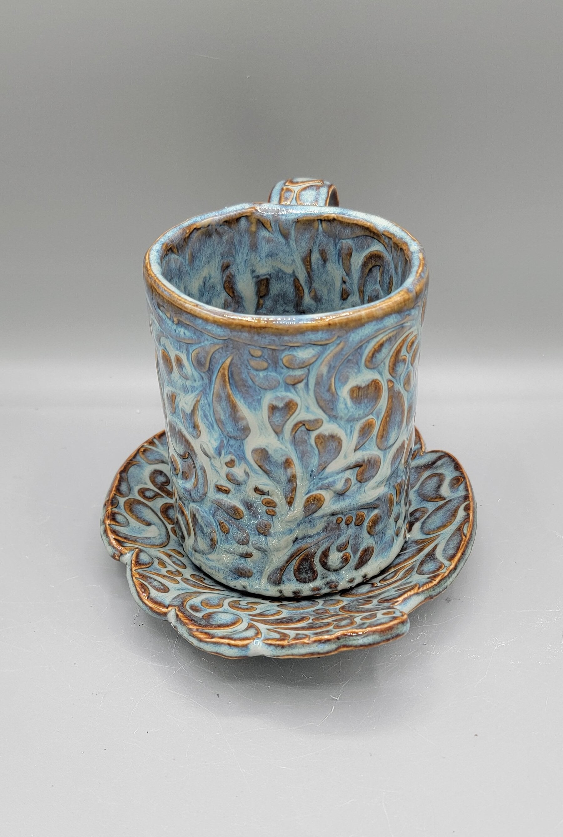 Embossed Paisley Ceramic Mug with Matching Fancy Saucer in Floating Blue