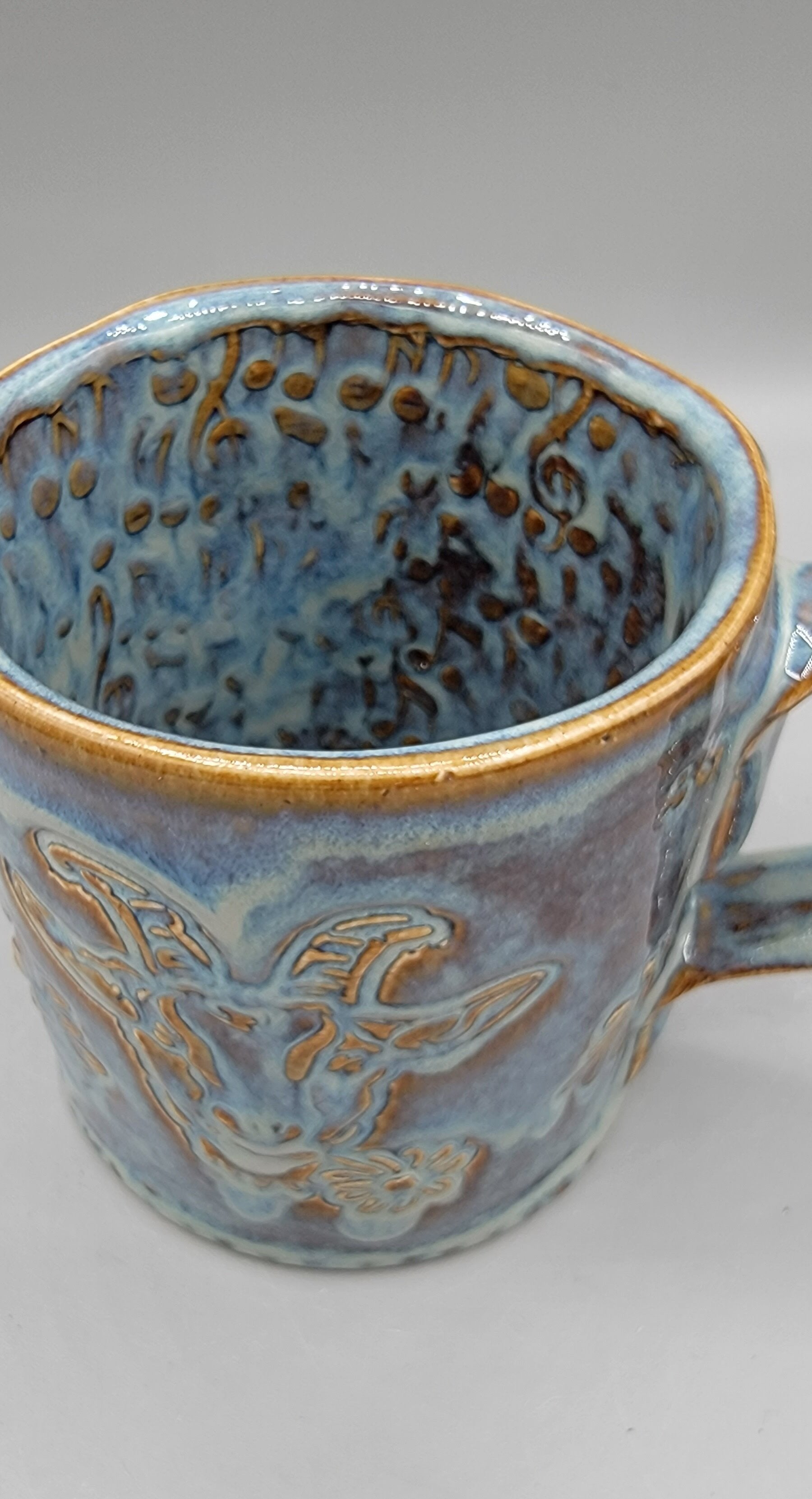 14-15oz Embossed BMFS Happy Goat Ceramic Mug in Floating Blue With Music Notes on Inside